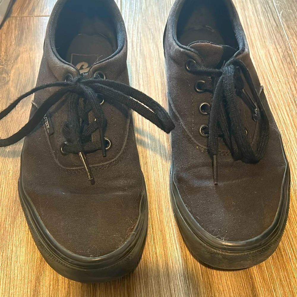 All black, lace up vans. Size 7W USA